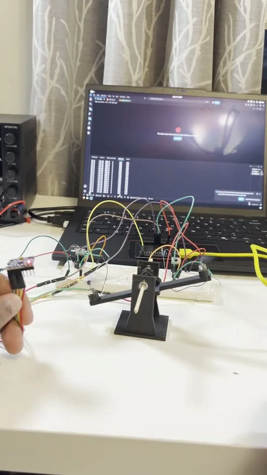 Pitch-axis rig: the arm level on its stand, ESP32 and MPU6050 wired to a laptop running the serial plot